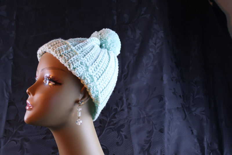 Crochet hat with adjustable brim is soft and comfortable.  It features a pom pom on top